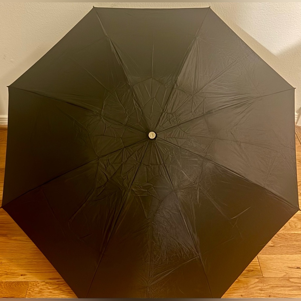 The Totes InBrella Reverse Close ECO Compact umbrella in black features